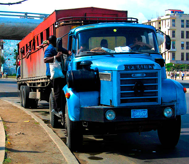 Public transportation in Havana, Cuba. Big, ugly trailer truck converted to haul big number of riders across the town.