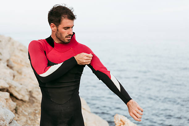 istock Surfer wearing wetsuit by the sea 2235050315
