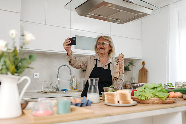 istock Senior woman making a selfie while cooking in a modern kitchen 2235050805