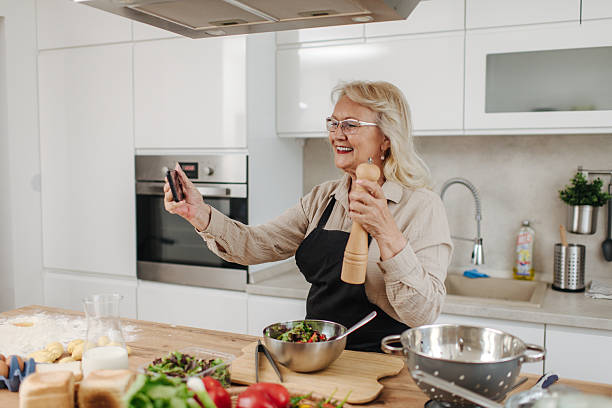 istock Senior woman making a video recipe in a modern kitchen 2235050809
