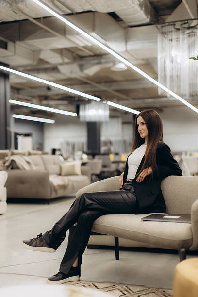 istock Professional Woman Relaxing on a Modern Sofa in a Stylish Workspace 2235052446