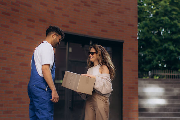 istock Courier delivering package to happy customer at home 2235052448