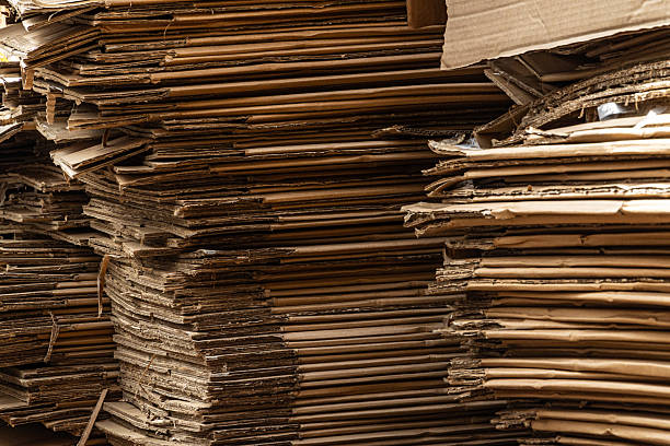 istock A vertical close-up of a large stack of cardboard boxes, showing the compressed layers and raw edges. 2235052984
