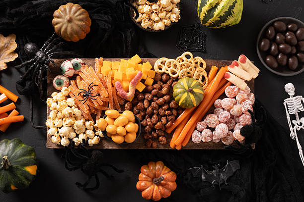 istock Halloween charcuterie board with pumpkin, chocolate candy, spider, crackers. 2235057060
