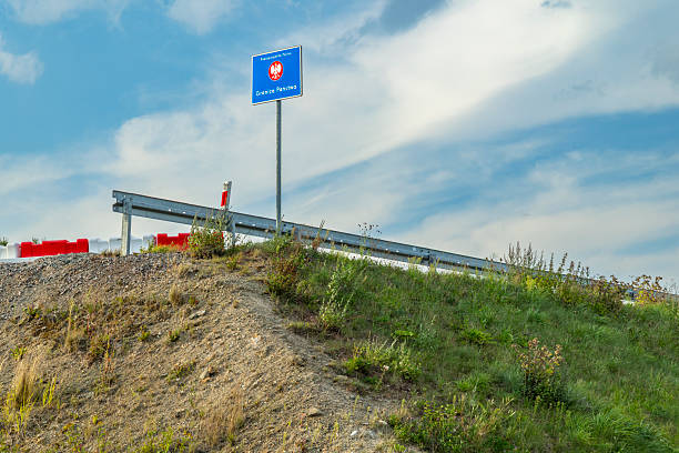 Polish border sign marking the state boundary with Czechia under a cloudy sky