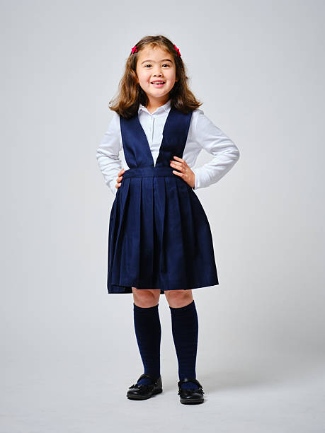 A young multiracial girl, wearing a school uniform.