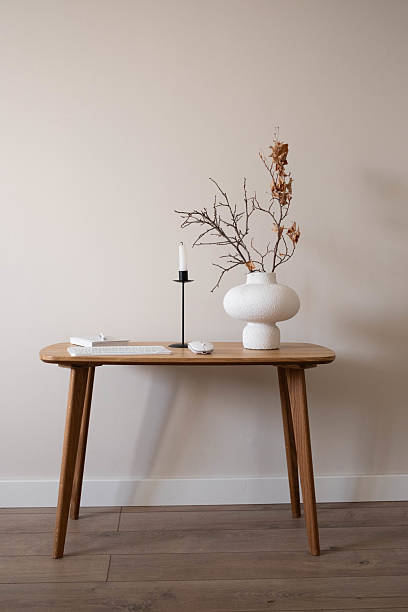 istock This stylish minimalist desk features natural decor, workplace with keyboard, notebook with pen for notes, ceramic vase with dry autumn branches. 2235060711