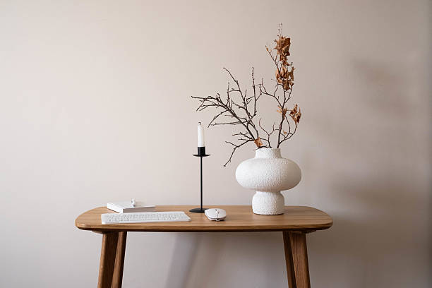 istock This stylish minimalist desk features natural decor, workplace with keyboard, notebook with pen for notes, ceramic vase with dry autumn branches. 2235060826