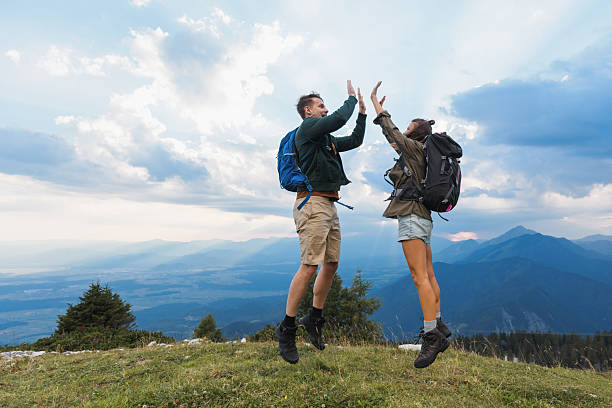 istock Couple celebrates at mountain summit 2235061792