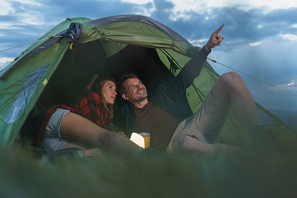 istock Couple enjoys stargazing inside their camping tent 2235061889