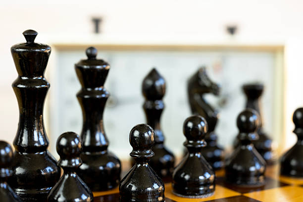 istock Chess pieces on a chessboard on the background of a chess clock. 2235062187