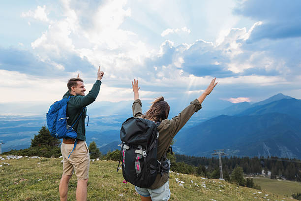 istock Couple at mountain top at sunset 2235062419