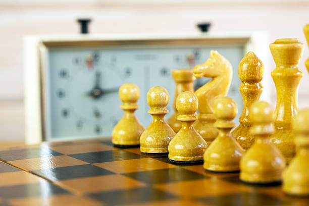 istock Chess pieces on a chessboard on the background of a chess clock 2235062848