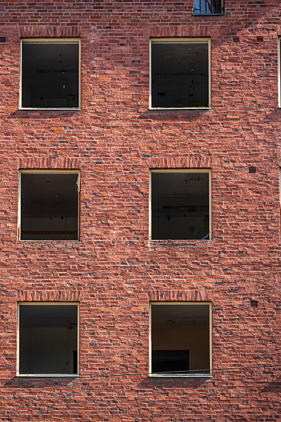 istock Closeup of red brick building wall windows.. 2235064059