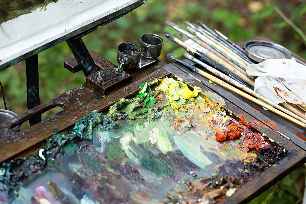 istock The artist mixes multi-colored paints on a palette for drawing. 2235064229