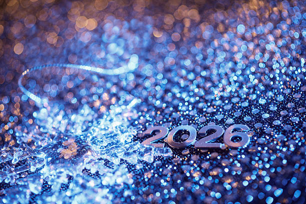 istock 2026 Silver Numbers with Ice Crystal Ornament on Sparkling Blue Background 2235064790