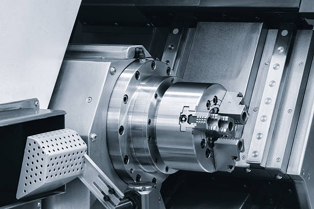 istock machine with a large, shiny, silver part. machine is in a workshop. The machine is used for cutting and shaping metal in blue tone 2235066404