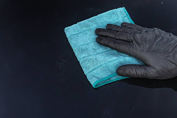 istock Wiping car wax from the car body with a blue microfiber cloth, 2235068135
