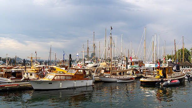 Victoria, BC, Canada - August 29, 2025: Glow warmly at sunset with shimmering water reflecting the colourful sky, boats gently bobbing, and the city's historic skyline creating a serene, picturesque scene.