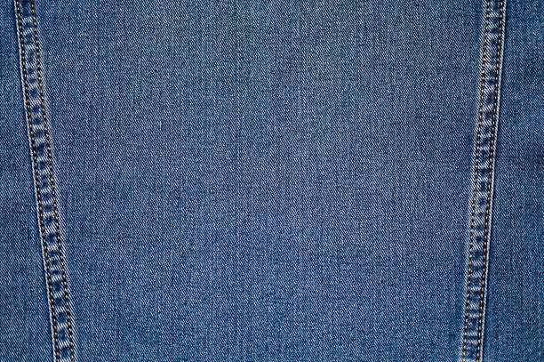 Denim background texture with double orange stitching seam