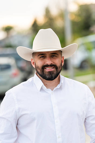 istock Hispanic man posing wearing a cowboy looking at camera 2235073647