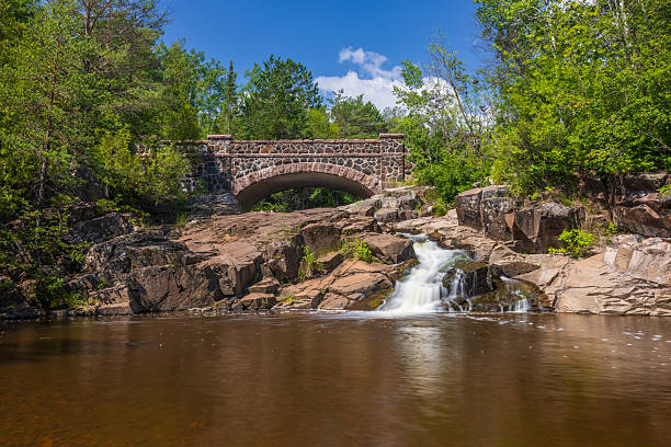 istock Stone Arch Bridge with Creek Waterfall 2235074354
