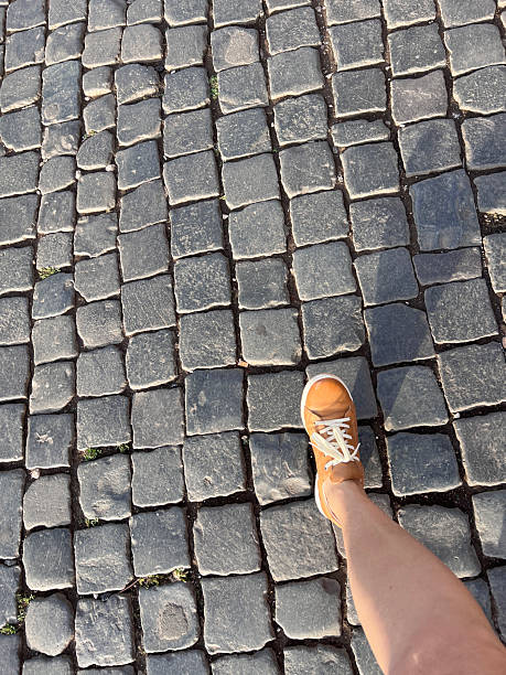 Stepping along the path in Rome, cobblestone reminding us that the path has been there for so very long. The stretch of shadow reminding us of the passage of time and to travel.