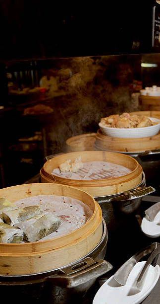 Steaming dim sum in bamboo baskets at restaurant, showcasing Asian