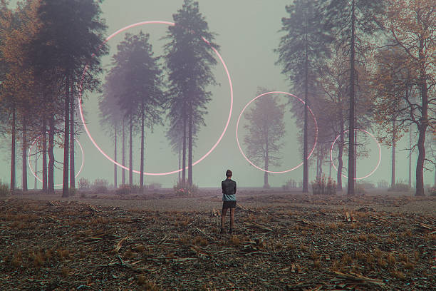istock Young woman standing in mysterious forest 2235094388