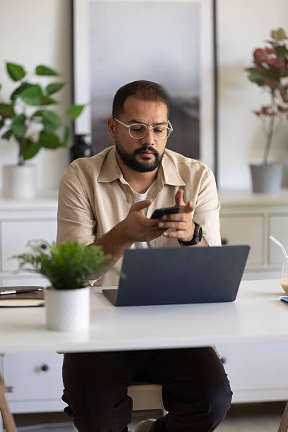 istock A businessman using a smartphone in a modern office. 2235094469