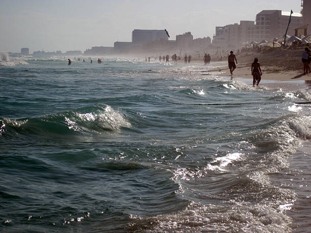 Cancun, Mexico - 12/29/2012: Hotels and bathers by Gulf of Mexico