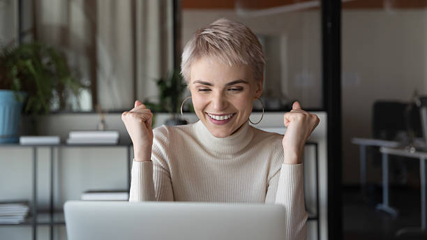 istock Excited happy short haired business woman using laptop 2235101365