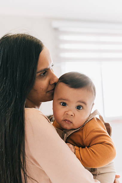 istock Mother holding baby close at home 2235101635