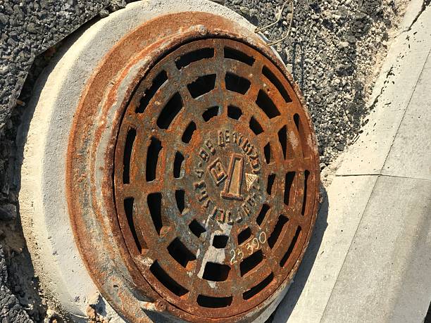 istock Rusty iron manhole set into asphalt road surfaces 2235102537