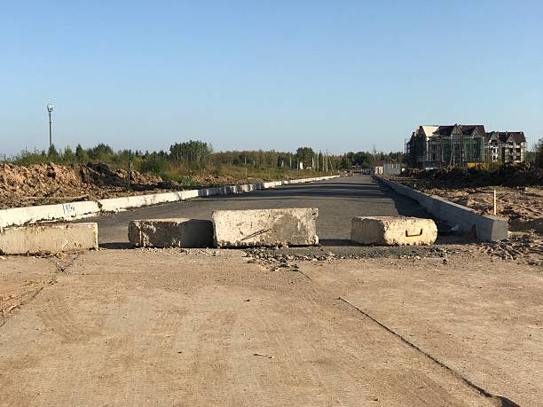 istock Road blocked with concrete blocks across the road 2235102591