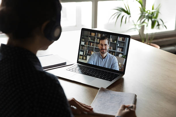 istock Student in headphones watching learning webinar, online business training 2235103653