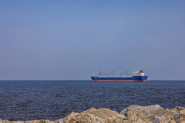 A blue cargo ship traveling on Great Lake Superior on its way to port.