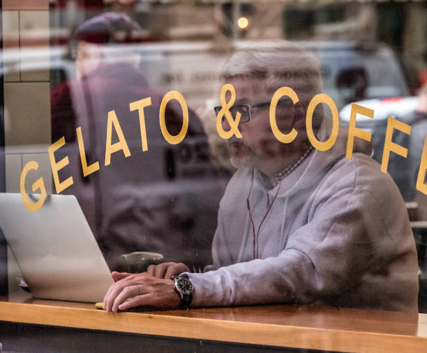 Washington DC USA Apr 3 2018: A mature man works on his laptop at a cafe in the Judiciary Square neighborhood  of Washington DC