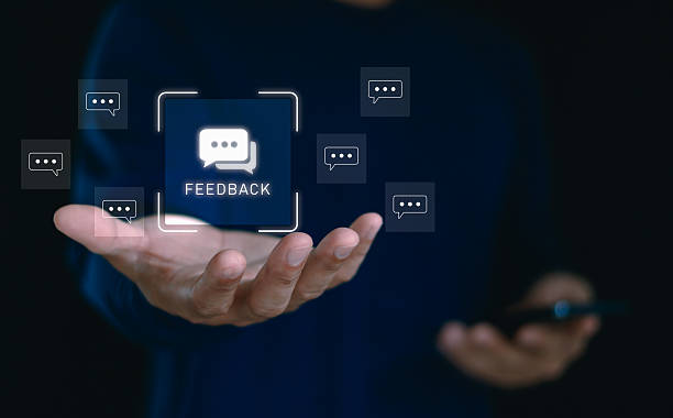 istock Businessman hand holding digital feedback icon with chat bubbles, representing customer review, communication, user experience, online survey, customer support service and business evaluation concept. 2235106420