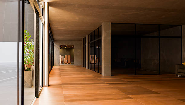 istock Modern office corridor with wooden floor and concrete walls - 3D render 2235109675