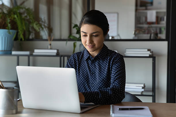 istock Focused positive Indian student girl using laptop for distance studying 2235110293