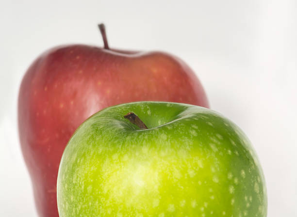 Red and green apple pair barely touching,