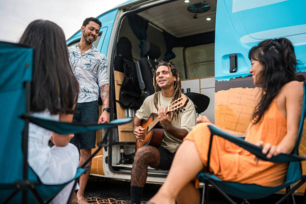 istock Diverse Friends Relaxing Outdoors Playing Guitar by Camper Van 2235121374