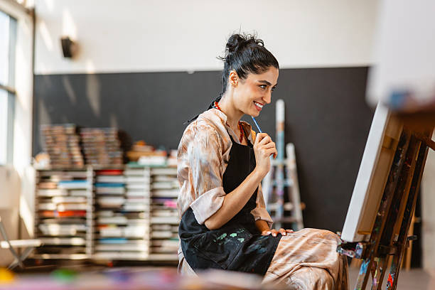 istock Young Middle Eastern Female Artist Painting in Studio 2235121449