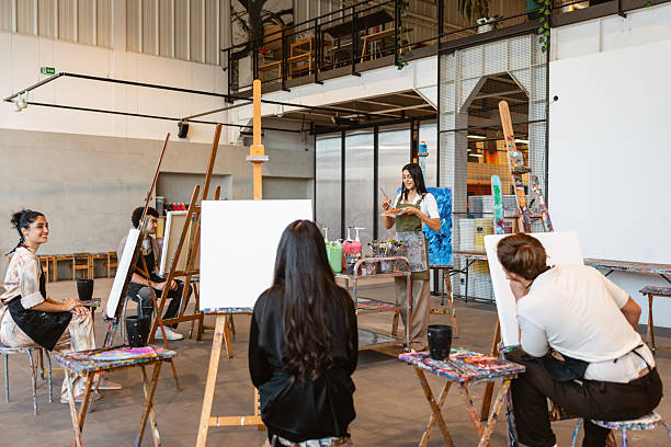 istock Young Middle Eastern Woman Leads Art Class with Diverse Group 2235121468