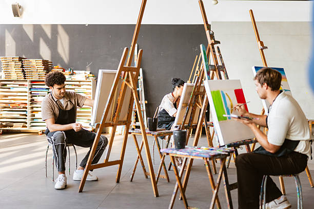 istock Diverse Artists Engaged in Lively Art Class Studio 2235121489