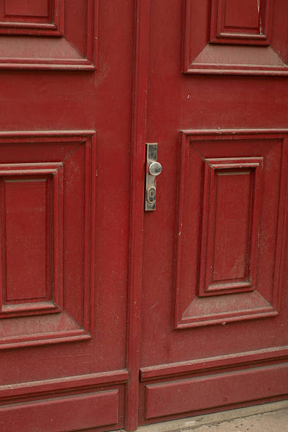 istock A closeup of a vibrant red door with a shiny silver handle 2235122850