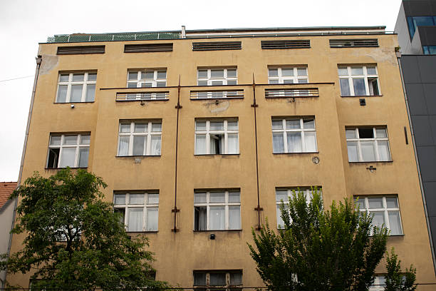 istock A tall building with many windows and trees in front of it 2235123017