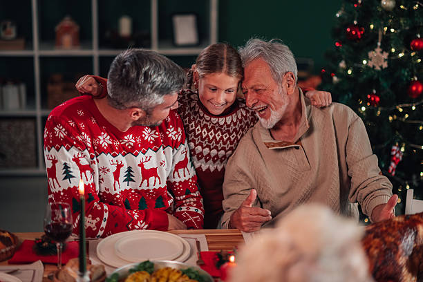 istock Family celebrating christmas dinner and embracing each other 2235125134