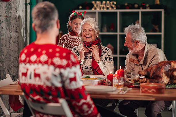 istock Family celebrating christmas dinner, wearing matching sweaters 2235125151